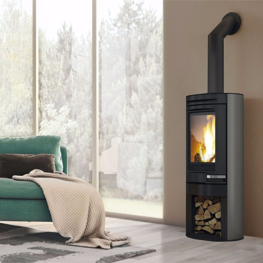 Edilkamin grauer Kaminofen Tally Int mit Holzlagerfach und Flammenbild in winterlichem Ambiente | klimaworld.com
