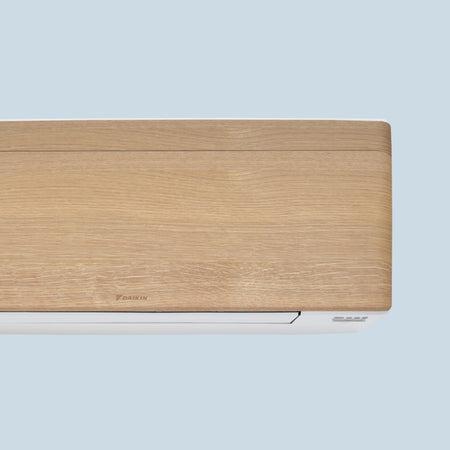 Daikin Stylish FTXA-DP Light Wood Wandgeraet, Detail der hellen Holzfront und weissen Unterseite, abgerundete Seiten | Klimaworld.com
