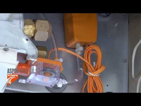 Installation of the Aspen Pumps mini orange in a ceiling mounted air conditioning unit.